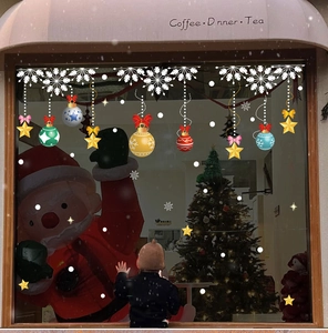Detailed Christmas window decals showing festive ornaments and white snowflakes on glass