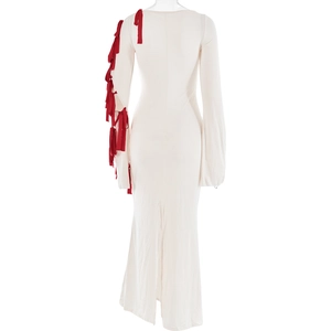 Detail of white dress back view with red ribbon bows on long flared sleeves and leg slit