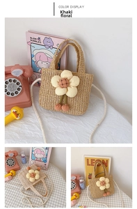 Close-up of kids' khaki straw bag featuring a large yellow flower and cherry charms