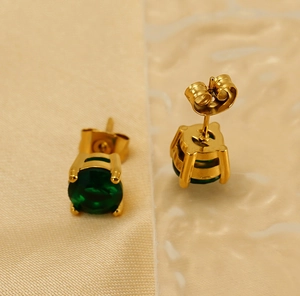 Detail view of round green zircon earrings with 18k gold plating and butterfly backings