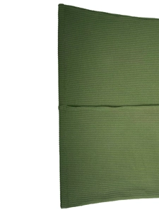 Detailed macro view of the green ribbed fabric texture for these casual trousers