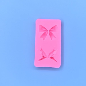Pink silicone mold featuring bow and butterfly shapes for DIY cake baking and crafts