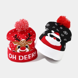 Festive Christmas beanie hats featuring reindeer and Santa Claus with soft pom-pom accents