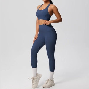Detail of high-waisted yoga pants featuring a convenient side pocket in navy blue fabric