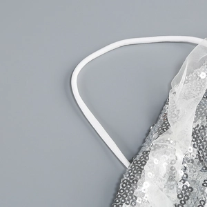 Detail of silver sequins and white mesh lace with elastic strap on halter dress