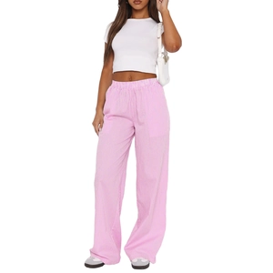 Detail of high waisted wide leg trousers with pink and white vertical stripes design