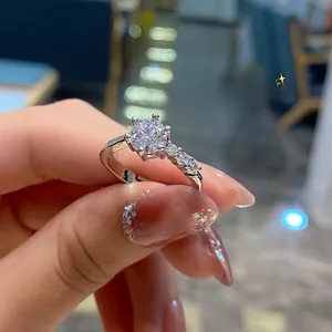 Macro shot of a six-prong silver engagement ring with brilliant round center diamond