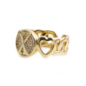 Detail of gold open ring featuring heart cutout and X-shape diamond-set design