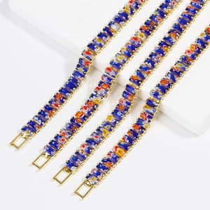 Deep blue floral patterned bracelet with golden edges on white tiered display stand