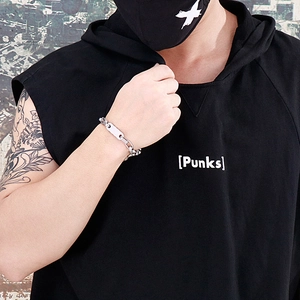 Close-up of punk style silver steel link bracelet with rectangular plate on male wrist