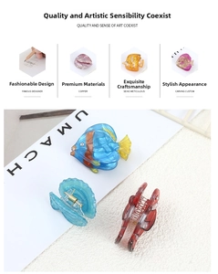 Detail of oceanic acetate hair clips with fish and shell motifs and copper hardware