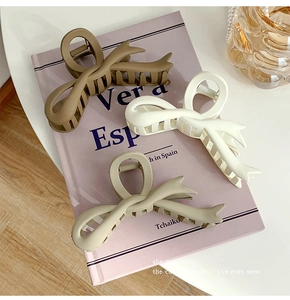Three matte bow hair claws in khaki, beige and grey colors for elegant styling