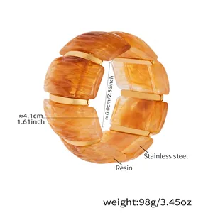 Bracciale elastico in resina ambrata con dettagli in acciaio dorato diametro 6cm