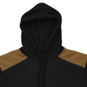 Close-up of drawstring hoodie featuring brown shoulder panels and quilted grid texture