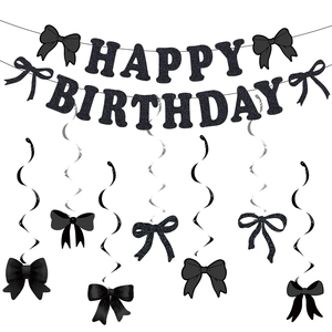 Detail of black glitter Happy Birthday banner with matching bow spiral party decorations