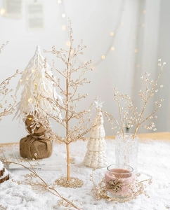 Detail of decorative champagne gold branch with crystal beads for holiday scenery