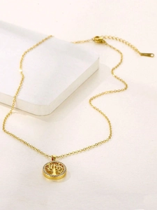 Macro detail of golden Tree of Life necklace with crystal halo on white geometric base