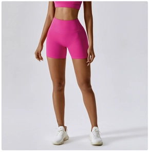 Detail of high-waisted yoga shorts in vibrant rose pink with firm tummy control support
