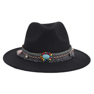 Detail of black fedora with bohemian woven band, turquoise stone, and fringe tassels