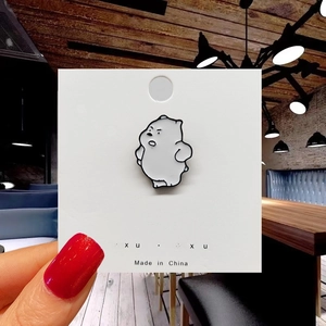 Detail of cute Ice Bear cartoon enamel pin with white oil drip and black outline