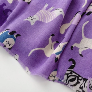 Detailed texture of purple cotton linen scarf featuring adorable cartoon cat patterns and fringes