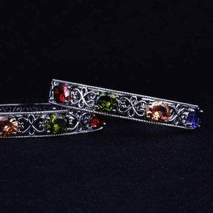 Silver hollow cuff bracelet set with vibrant round cut multicolor gemstones