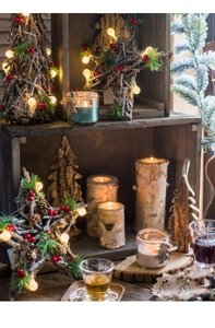 Detail of birch wood candle holders with LED Christmas tree and festive berry decor