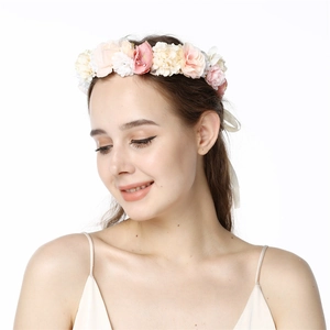 Detail of pink and white silk flower bridal headband with ribbons for styling