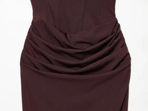 Macro shot of the wine red evening dress featuring elegant crisscross waist pleats