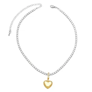 Two-tone heart necklace with gold pendant and silver tennis chain inlaid with cubic zirconia