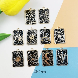 Set of 10 black and gold enamel tarot card pendants measuring 28x18mm with floral accents