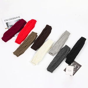 Close-up of diamond cable knit arm warmers in various colors showing texture and ribbing