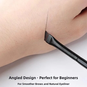 Macro shot of an angled eyeliner brush showing precise lines on skin for eye makeup