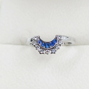 Macro detail of silver celestial ring featuring blue and white crescent moon stones