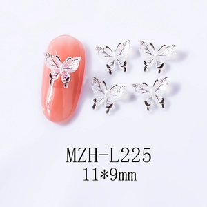 Macro shot of 11x9mm pearl white butterfly nail charms with black outlines and fine shimmer
