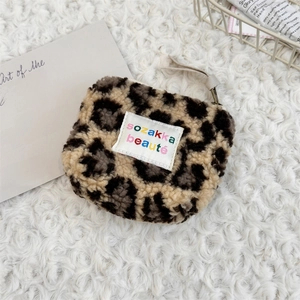 Detailed close-up of a plush leopard print mini pouch with a soft textured finish