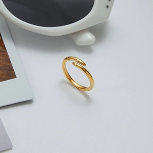 Detailed 45-degree angle view of a minimalist 18K gold-plated adjustable open ring