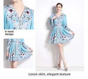 Detail view of V-neckline and elegant floral pattern on light blue chiffon dress