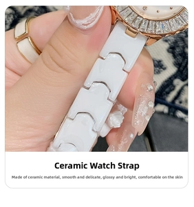 Detail of white ceramic H-link strap and rose gold rhinestone bezel on luxury watch