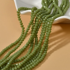 Detailed view of olive green faceted rondelle beads for DIY jewelry making and crafts
