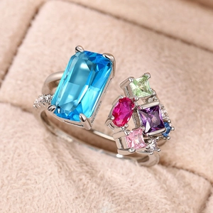 Luxury silver open ring with colorful zircon stones in geometric shapes on velvet
