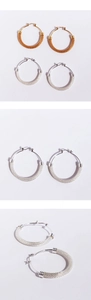 Detailed macro view of woven mesh texture on large silver and gold hoop earrings