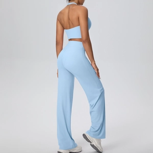 Detail view of light blue halter yoga top and high-waist loose pants from a side-back angle