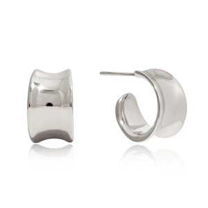 Macro view of polished silver C-shaped stainless steel earrings with mirrored finish