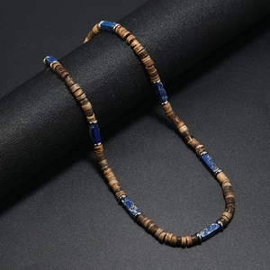 Detail of vintage bohemian necklace with brown coconut beads and blue natural stone accents