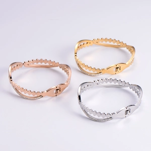 Chic gear-edged open bangles in gold, silver and rose gold with pavé crystal accents