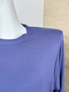 Close-up of a purple long-sleeved loungewear top with a crew neck and soft fabric