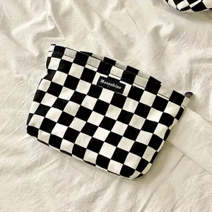 Classic black and white checkered canvas makeup bag with Moonshine logo on white fabric