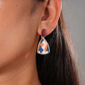 Detailed view of geometric resin drop earrings with pearl flowers on a female model