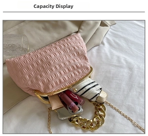 Detail view of pink pleated dumpling bag interior showing large capacity for essentials